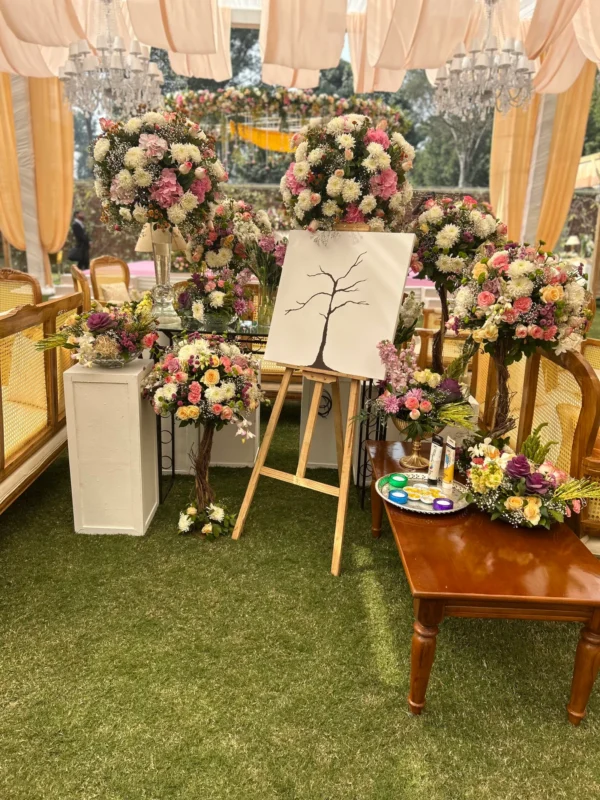 Floral welcome display with candles and personal details